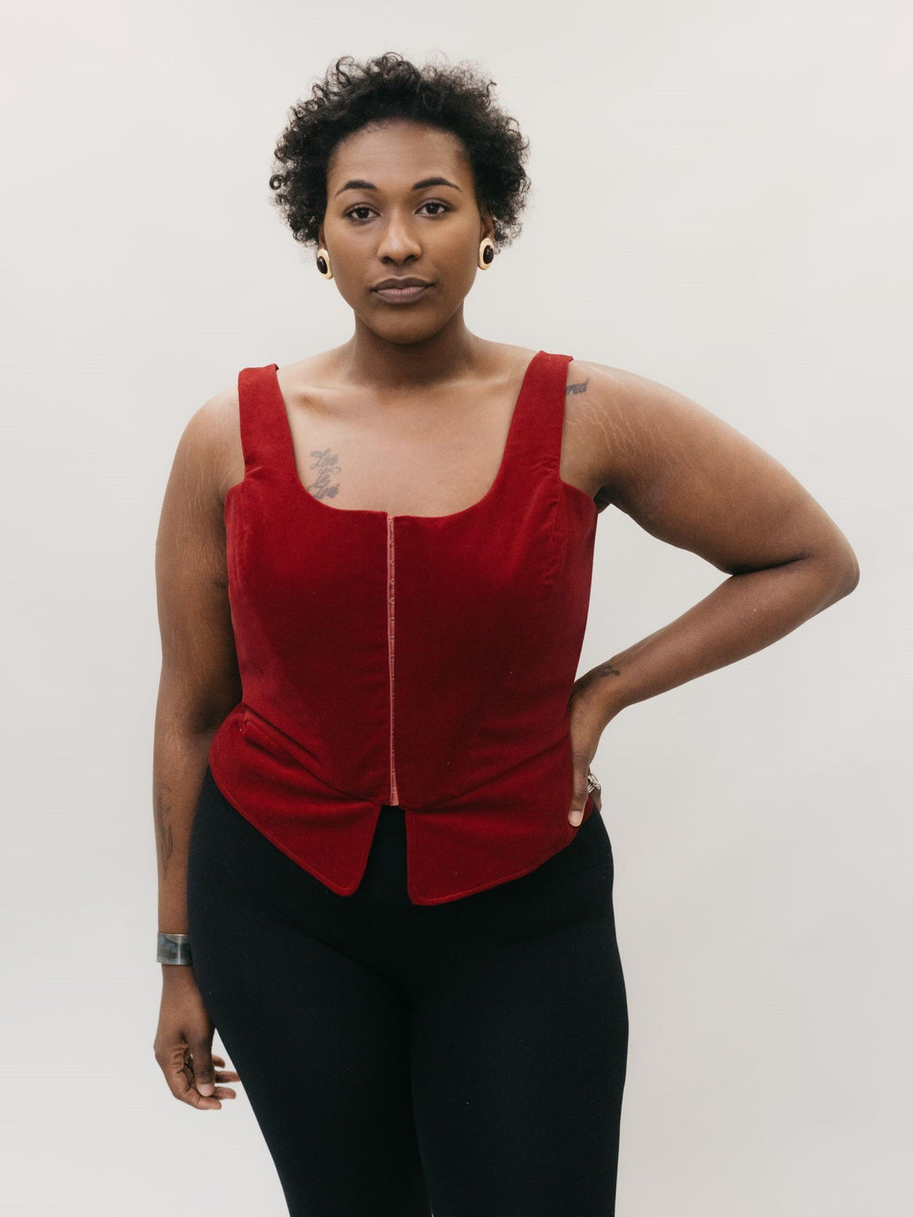 Woman wearing the 267 M'Lady's Corset sewing pattern from Folkwear on The Fold Line. A corset pattern made in silk satin, brocade, damask, shantung, dupioni, cotton damask, brocade, linens and blends fabrics, featuring a square-neck, sleeveless, laced bac