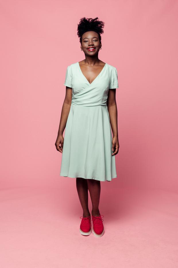 Woman wearing the Johanne Dress sewing pattern from Melilot on The Fold Line. A wrap dress pattern made in silk, linen, cotton or viscose fabrics, featuring short sleeves, wrap closure with 3 button bodice closure, bust darts, deep V-neck, knee length hem