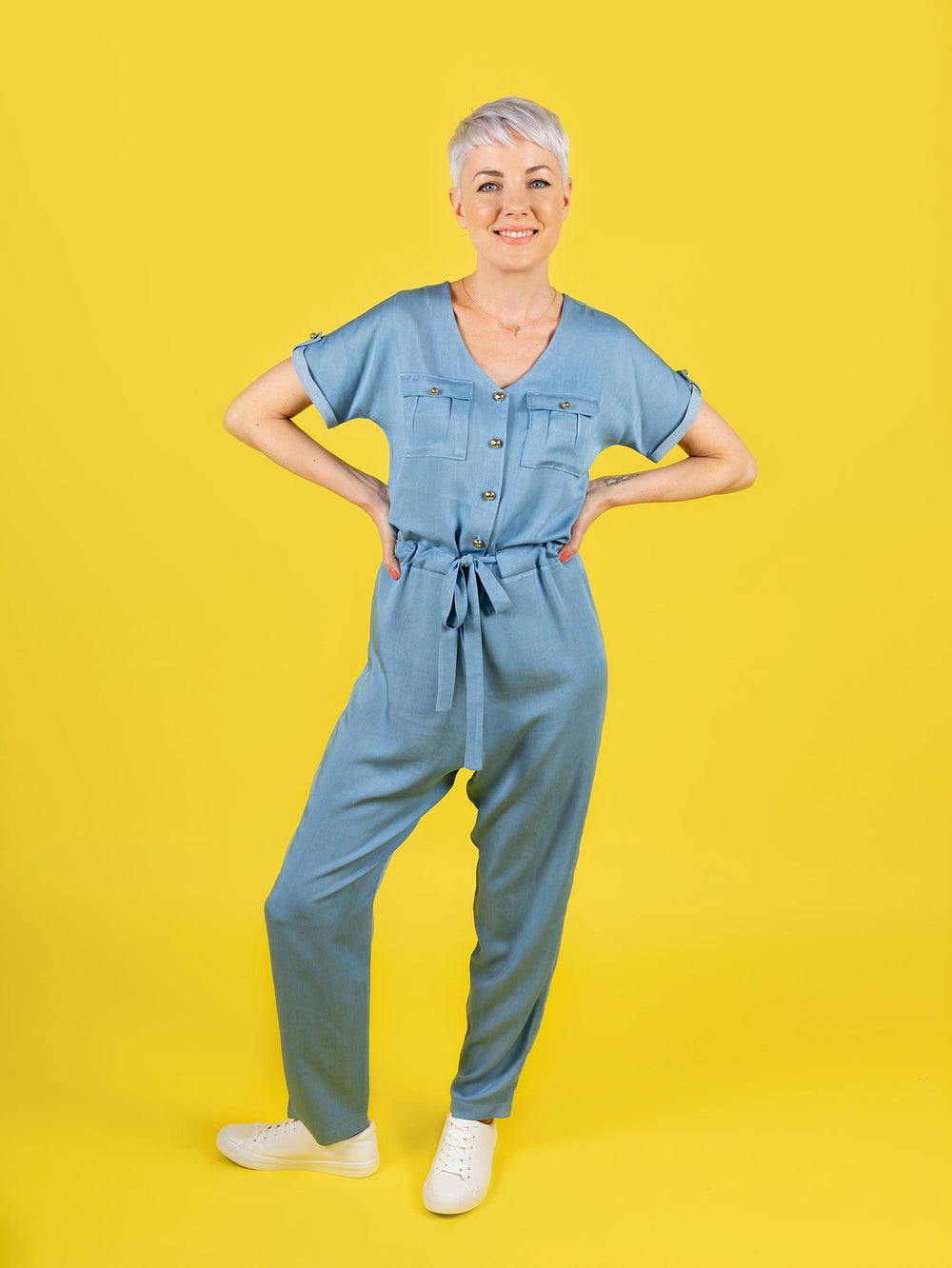 Woman wearing the Alexa Jumpsuit sewing pattern from Tilly and the Buttons on The Fold Line. A jumpsuit pattern made in linen, chambray, viscose (rayon), lyocell (Tencel), cotton lawn, double gauze, or crepe de chine fabric, featuring a curved V-neckline,