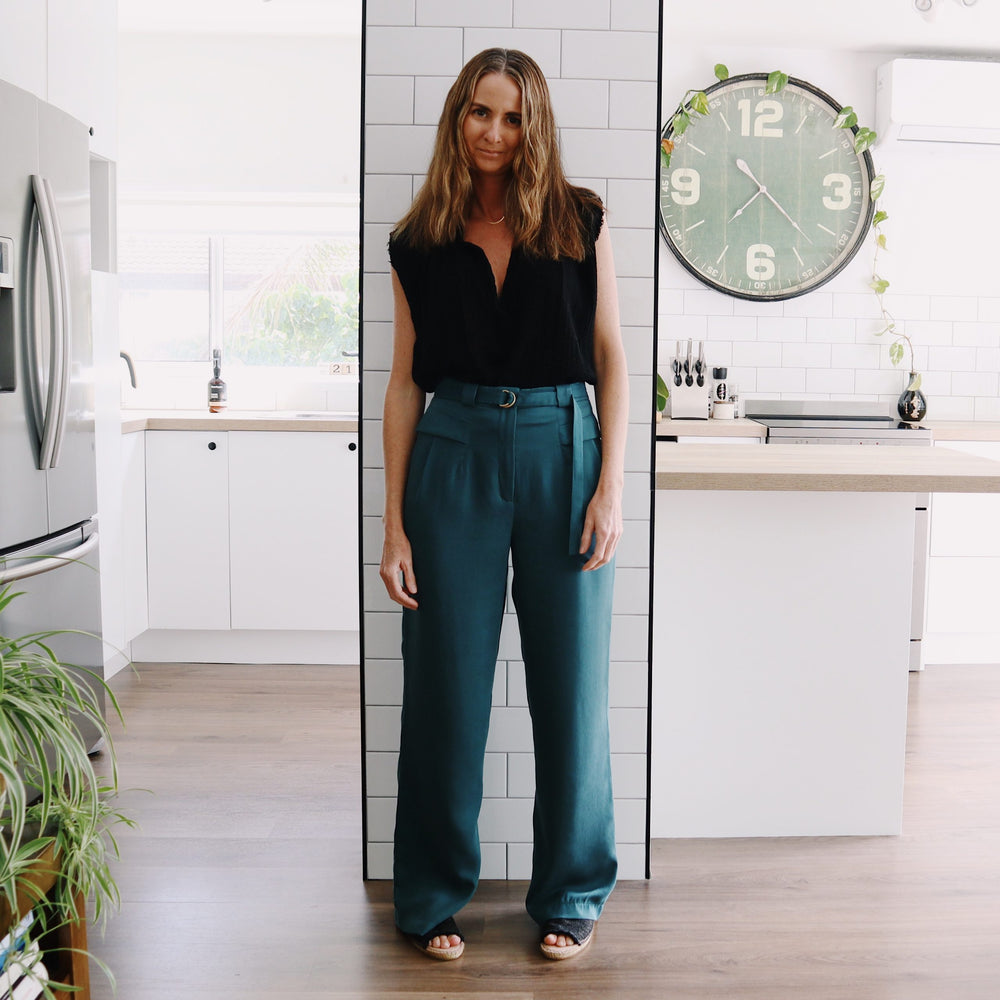 Woman wearing the Alexis Pant sewing pattern from Marsha Style on The Fold Line. A trouser pattern made in linen, cotton, tencel, viscose, rayon, wool or blends of these fabrics, featuring a mid-rise, slouchy fit, fly front, button or hook and bar closure