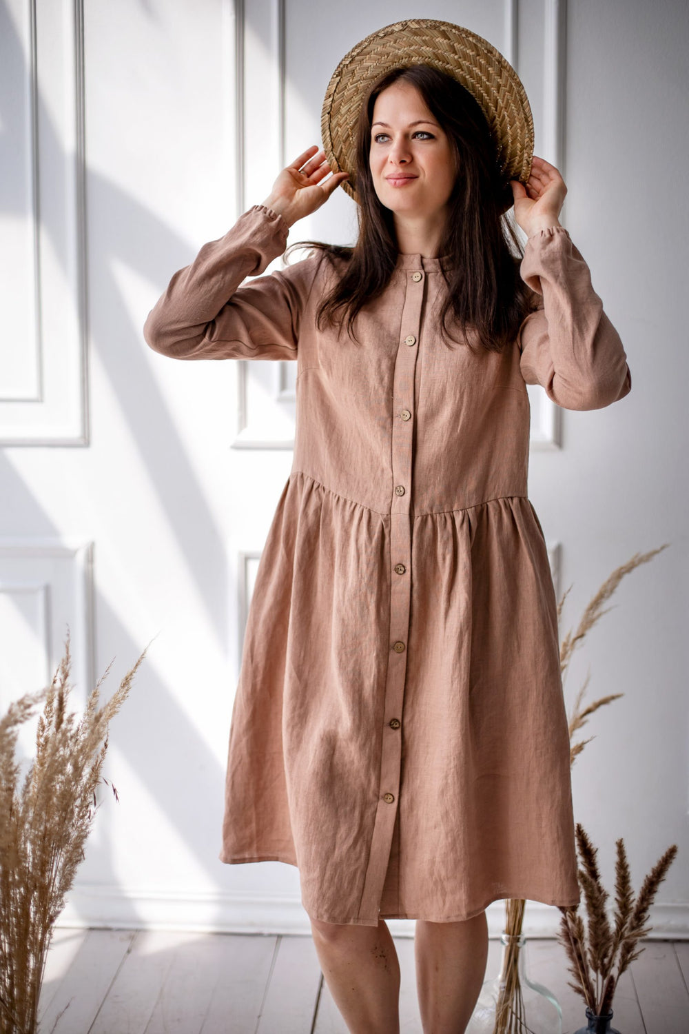 Woman wearing the Alice Dress sewing pattern from Kates Sewing Patterns on The Fold Line. A shirt dress pattern made in wool, linen or cotton fabrics, featuring a band collar, bust darts, button placket, gathered skirt, full length sleeves with elasticate