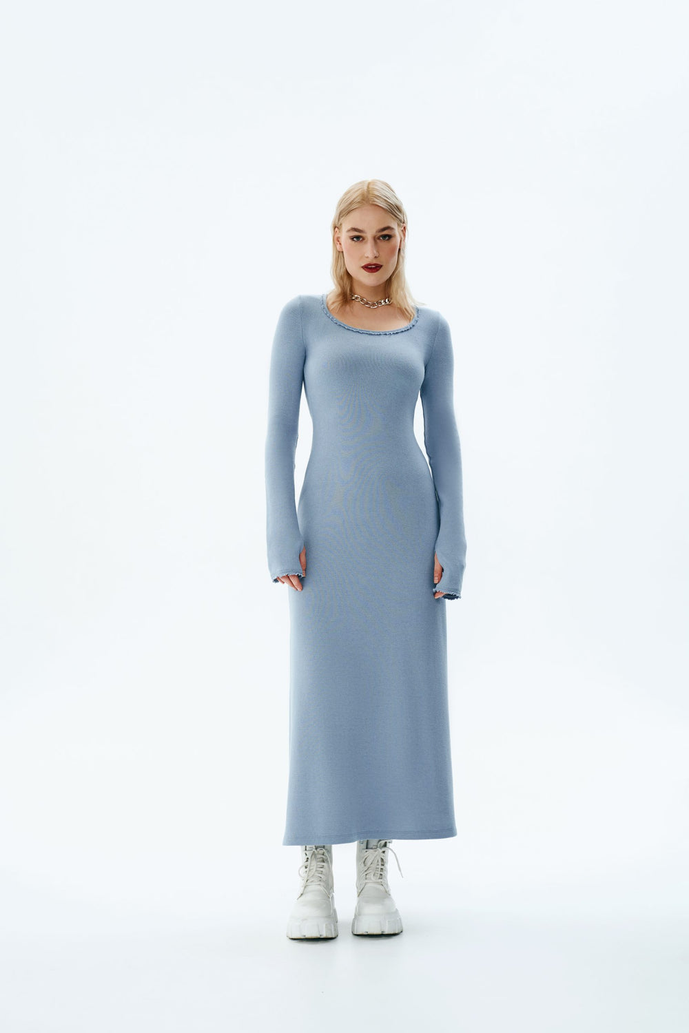 Woman wearing the Alison Dress sewing pattern from Vikisews on The Fold Line. An dress pattern made in sweater knits, rib knits, or jersey fabrics, featuring a close-fit, flared at the hem, low round neckline, bust darts, long close-fitting one-piece set-