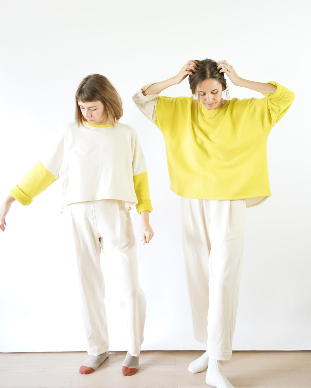 Women wearing the All Around Crew sewing pattern from Matchy Matchy Sewing Club on The Fold Line. A top pattern made in french terry, sweatshirt fleece, and jersey fabrics, featuring a cropped or tunic length, wide relaxed fit, dropped shoulders, gently c
