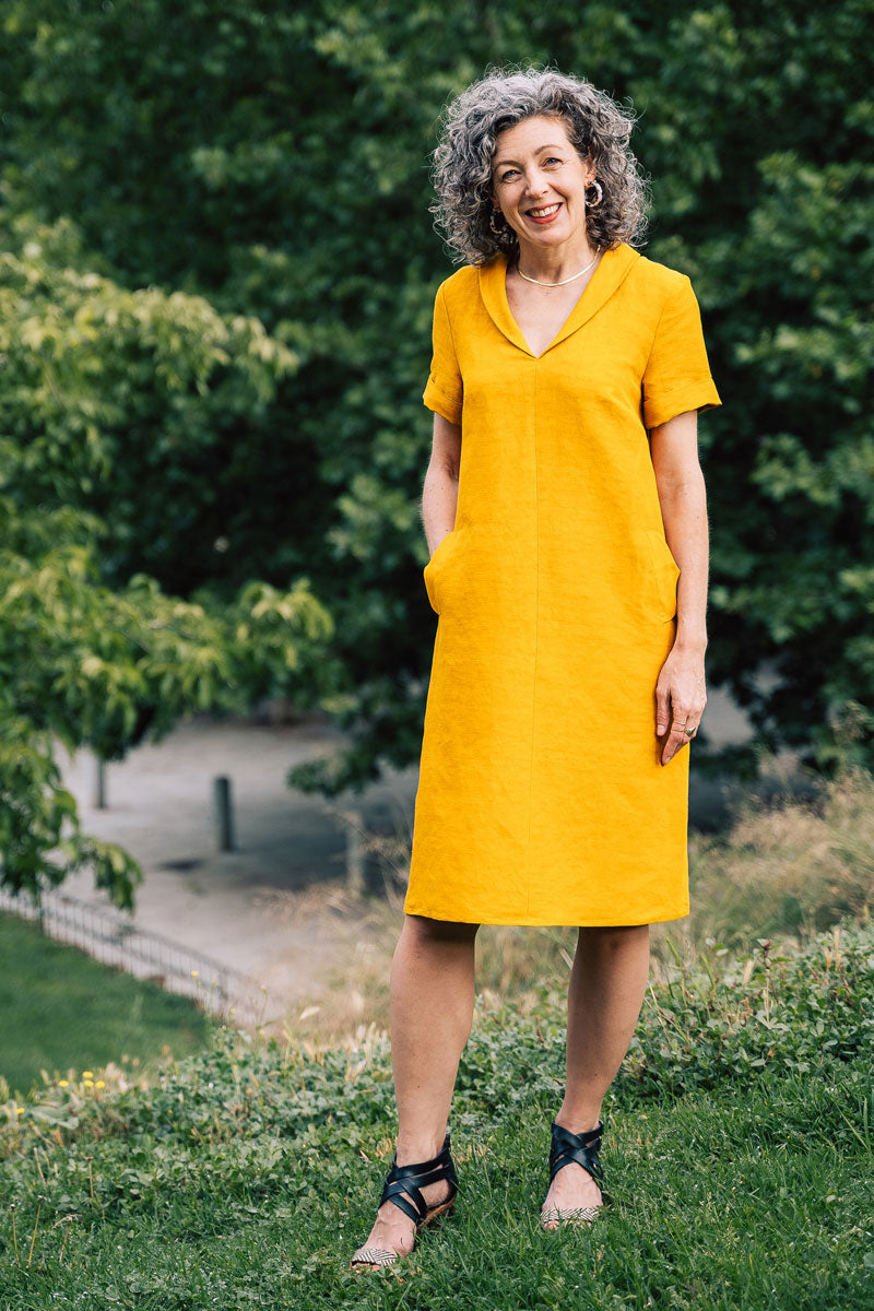 Woman wearing the Amarena Dress sewing pattern from Liesl + Co on The Fold Line. A dress pattern made in linen, rayon, cotton sateen, pinwale corduroy, lightweight denim or chambray, and lightweight canvas fabrics, featuring a pull-on style, gentle A-line