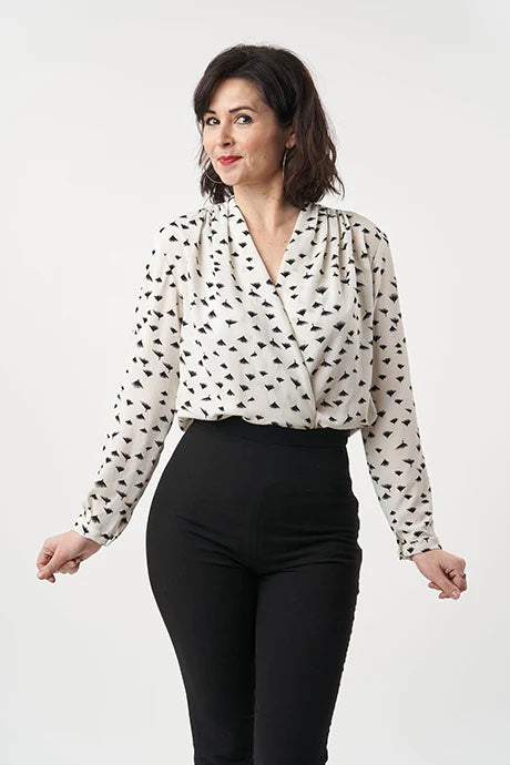 Woman wearing the Anderson Blouse sewing pattern from Sew Over It on The Fold Line. A blouse pattern made in crepe de chine, satin, sandwashed silk, lightweight crepes, or rayon fabric, featuring a wrap front, gathered shoulders, full length sleeves, and 