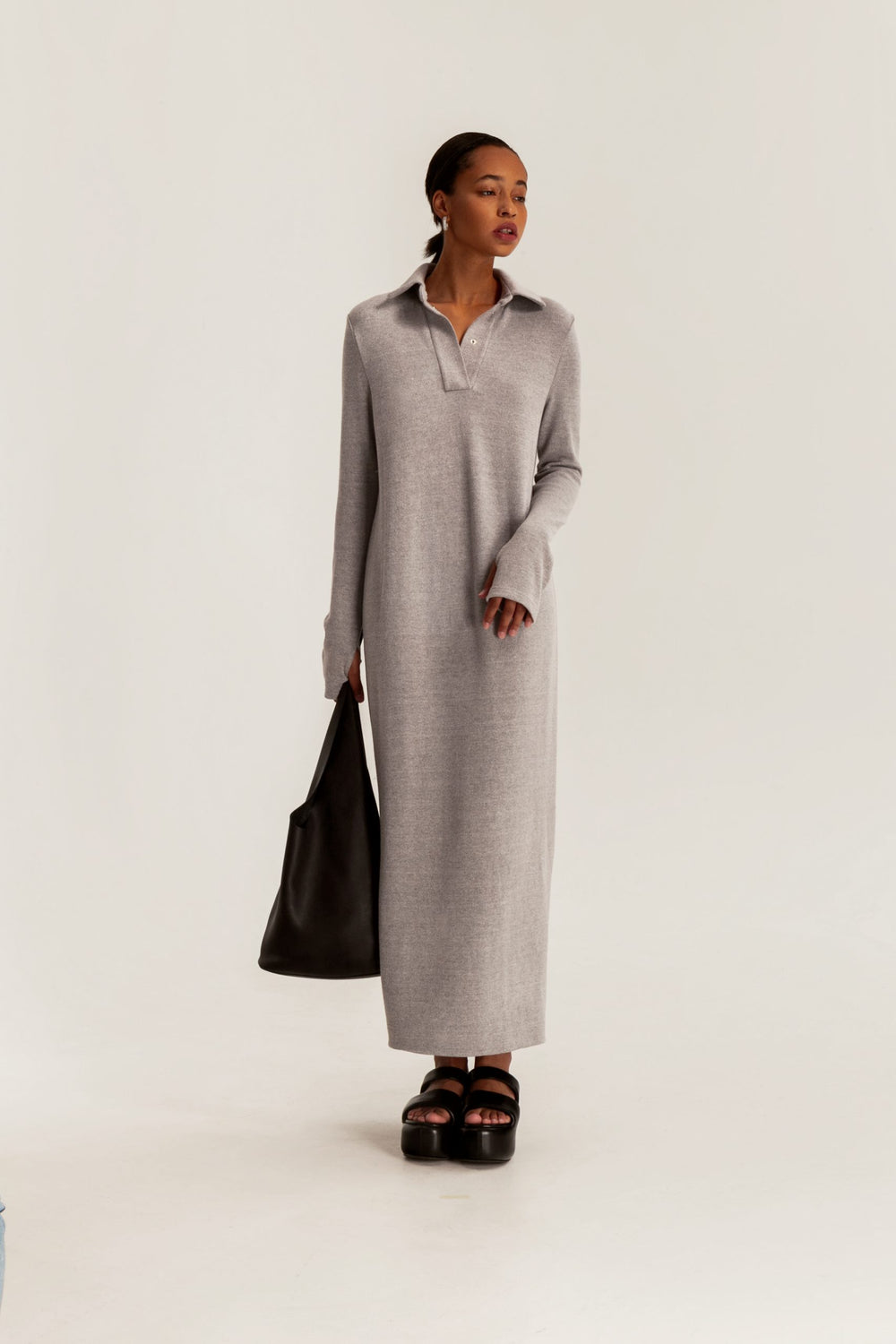 Woman wearing the Andie Dress sewing pattern from Vikisews on The Fold Line. A dress pattern made in sweater knit fabrics, featuring a semi-fit, straight cut, bust darts, turn-down collar, collar stand, henley placket with set-in snaps, long set-in sleeve