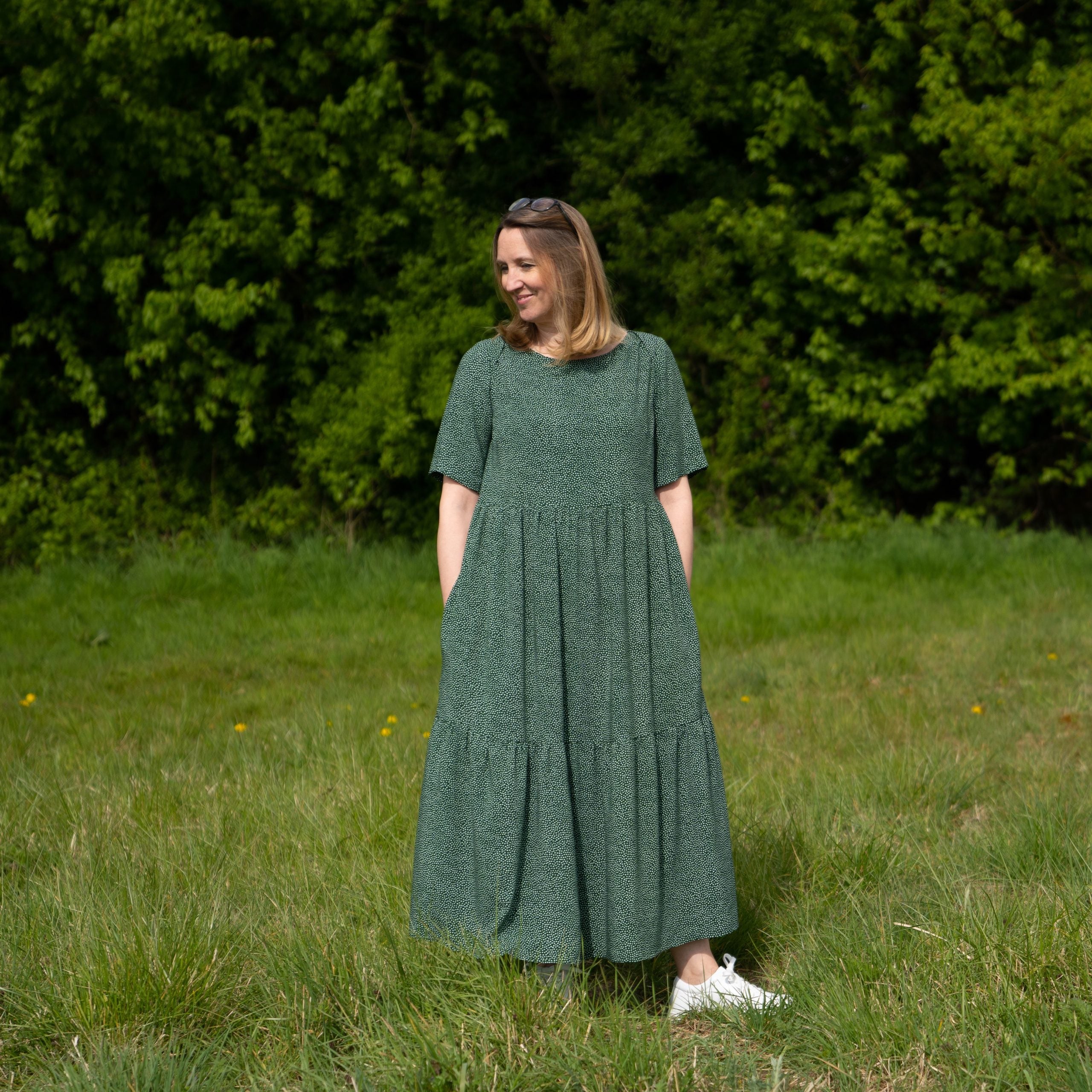 Woman wearing the Angelica Dress sewing pattern from Sew Me Something on The Fold Line. A dress pattern made in linen, viscose rayon, double gauze, cotton lawn, or broderie anglaise fabrics, featuring an ankle length, elbow length sleeves, gathered shirt 
