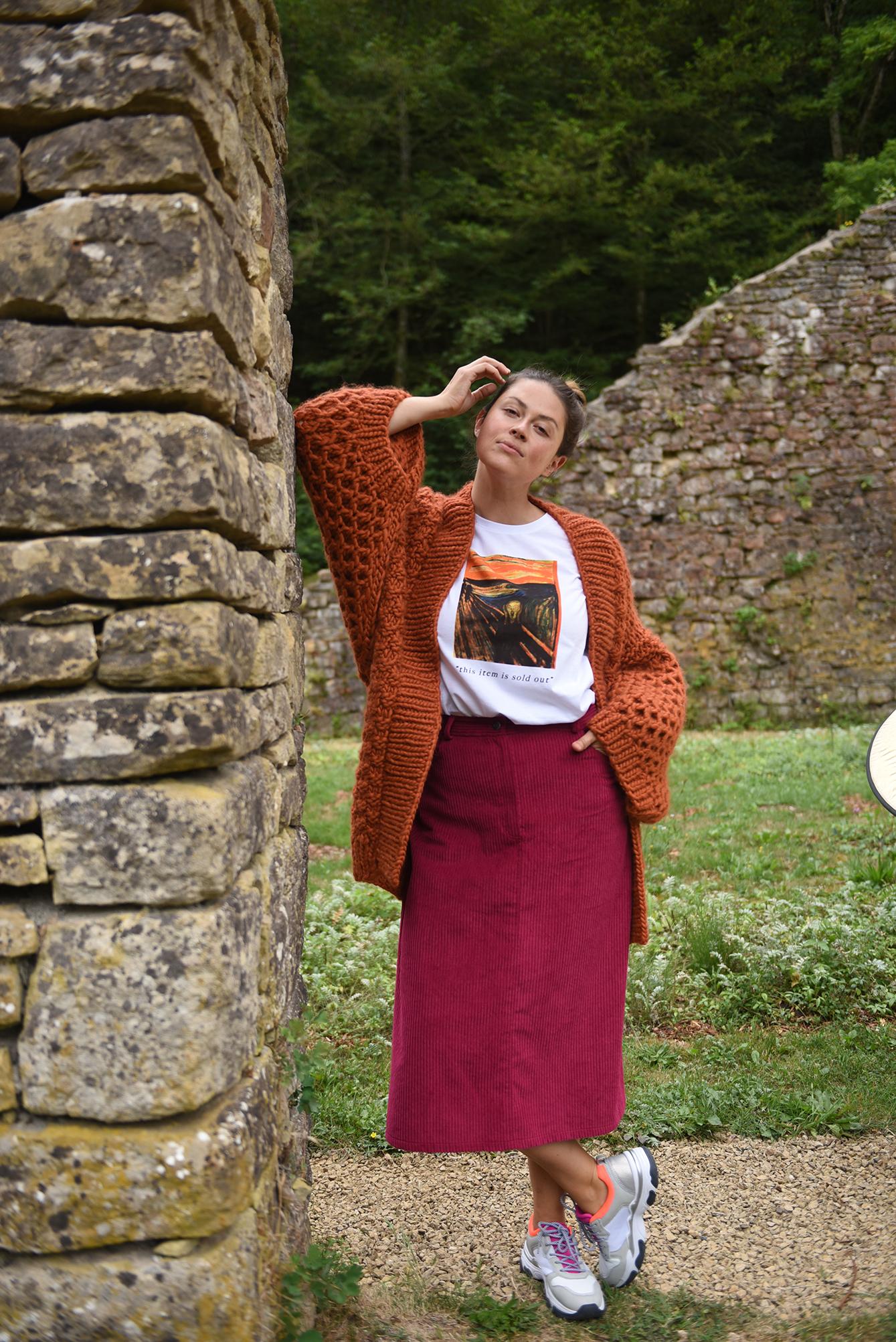 Woman wearing the Anna Skirt sewing pattern from Fibre Mood on The Fold Line. A skirt pattern made in cotton, denim or corduroy fabrics, featuring an A-line shape, fly-front zip closure, overlapping slit at the back and midi length hem.