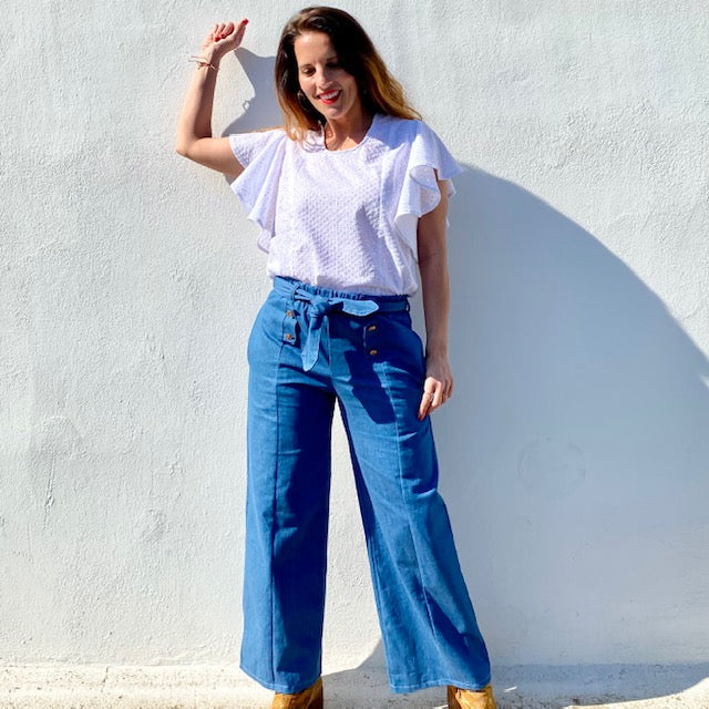 Woman wearing the April Pants sewing pattern from You Made My Day on The Fold Line. A trouser pattern made in cotton, Tencel, or viscose fabrics, featuring a straight-cut, front seams, side pockets, elastic waistband, belt, belt loops, and front false but
