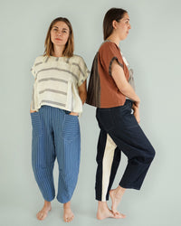 Woman wearing the Archer Work Pants sewing pattern from Matchy Matchy on The Fold Line. A trouser pattern made in linen, cotton, rayon, cotton twill, canvas or denim fabrics, featuring an easy-fit, barrel-shape, askew front pockets, contrasting inseam pan