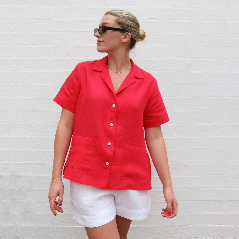 Woman wearing the Arkie Shirt sewing pattern from Tessuti Fabrics on The Fold Line. A shirt pattern made in cotton, viscose, linen or silk fabrics, featuring a hip length, short sleeve, front button closure, revere collar, side splits, patch pockets and b