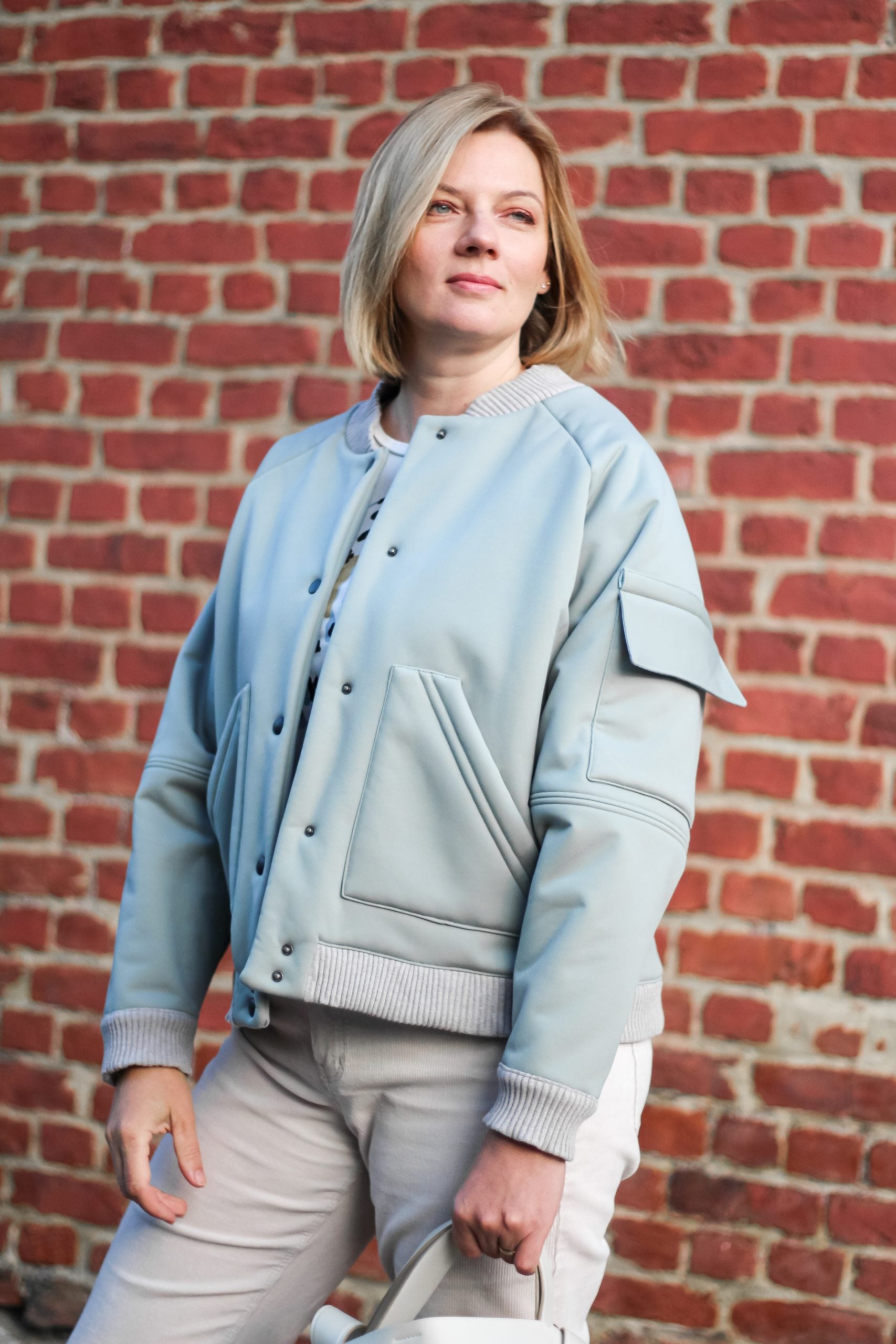 Women wearing the Arthur Bomber Jacket sewing pattern from Lenaline Patterns on The Fold Line. A bomber jacket pattern made in Jersey, quilted fabrics, chino, denim, jacquard, imitation leather, gabardine cotton, velvet, or softshell fabrics, featuring fr