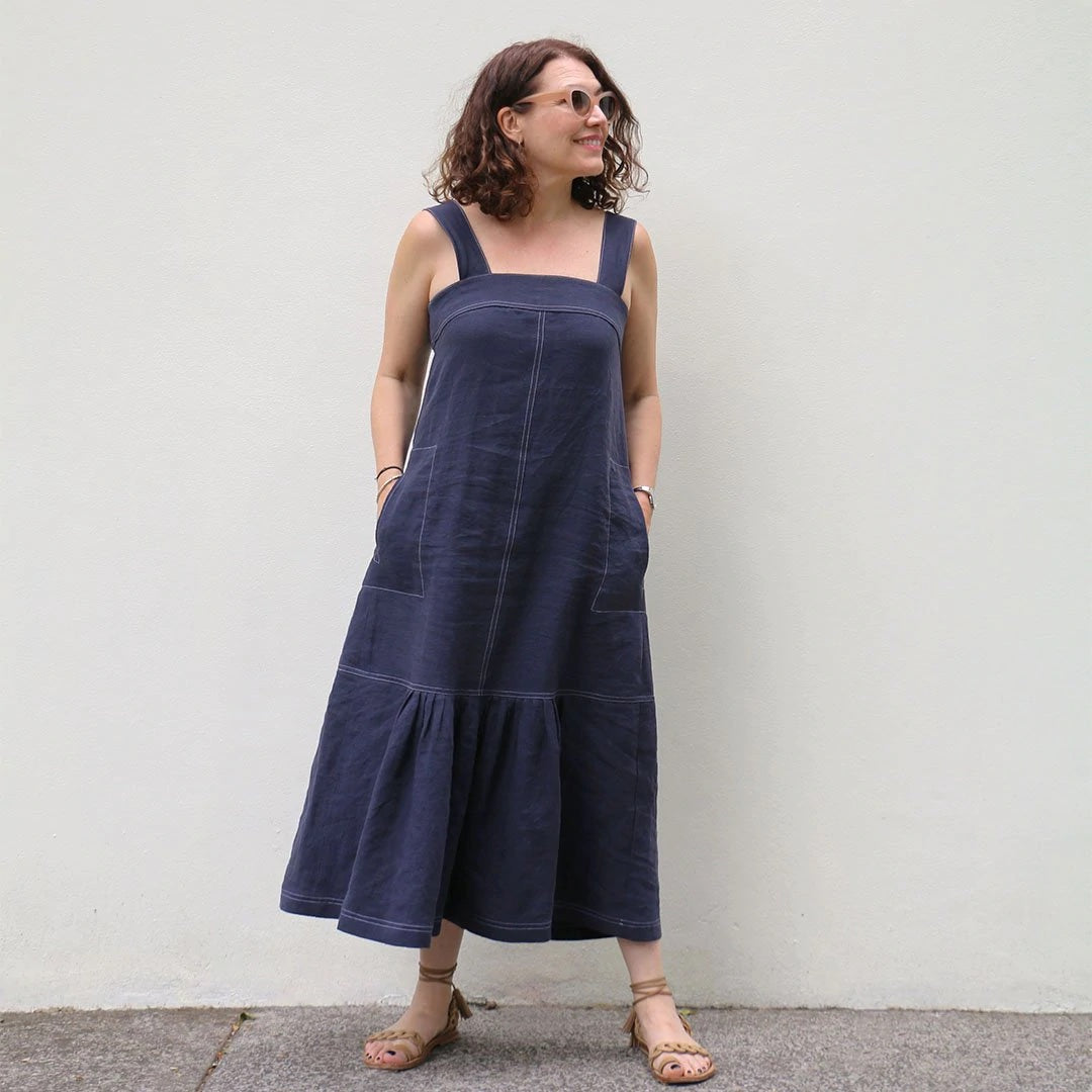 Woman wearing the Astrid Sundress sewing pattern from Tessuti Fabrics on The Fold Line. A sundress pattern made in linen or cotton fabrics, featuring a midi-length, wide shoulder straps, centre front and back seams, forward side seams with in-seam pockets