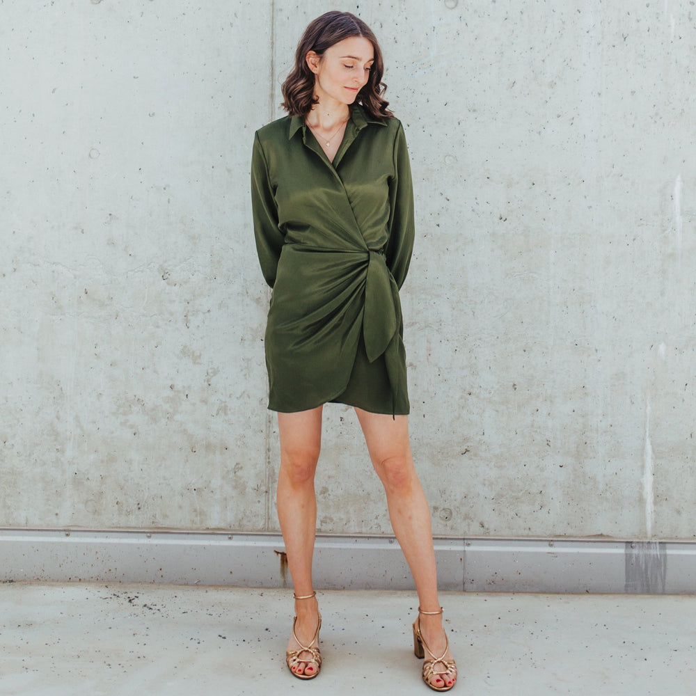 Woman wearing the Atlas Wrap Dress sewing pattern from Sewing Patterns by Masin on The Fold Line. A wrap dress pattern made in viscose/rayon, satin, crepe, cotton poplin or shirting, or lightweight linen fabrics, featuring a mini length hem, collar and st