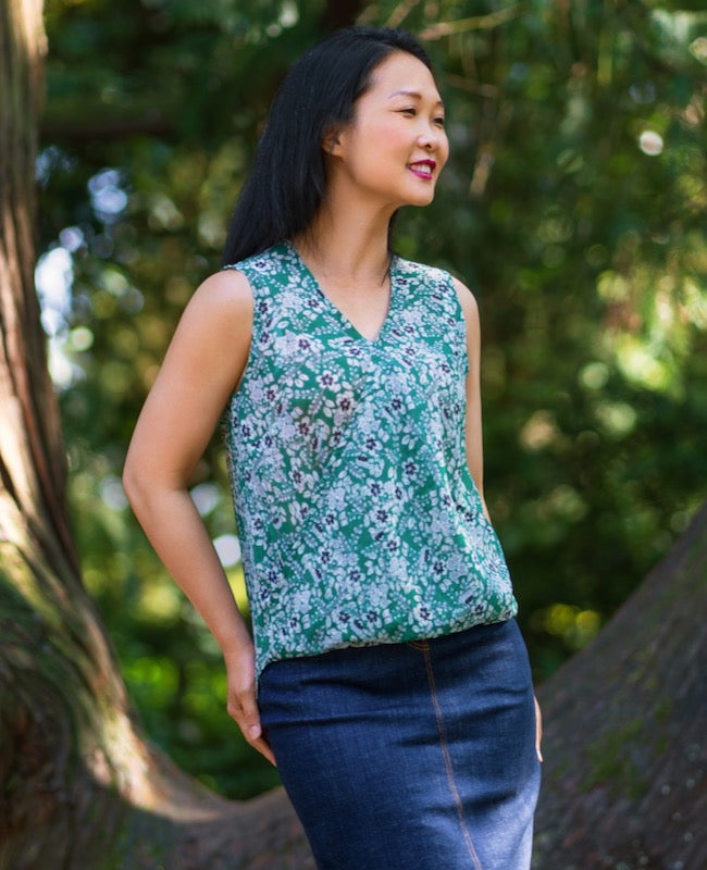 Woman wearing the Auvers Top sewing pattern from Itch to Stitch on The Fold Line. A sleeveless top pattern made in chiffon, georgette, rayon challis or charmeuse fabrics featuring front halves cross diagonally to create a V neckline, elasticated front hem