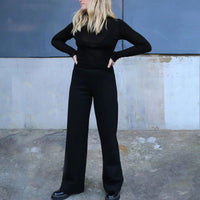 Woman wearing the Avalon Pants sewing pattern from Tessuti Fabrics on The Fold Line. A trouser pattern made in ponti knit, stretch cotton French terry, stretch cotton brushed back fleece, stretch velvet or viscose/elastane jersey fabrics, featuring a pull