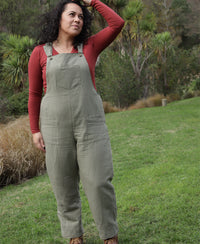 Woman wearing the Tipa Dungarees sewing pattern from Below the Kowhai on The Fold Line. A dungaree pattern made in light to medium weight cotton, chambray, linen, medium to heavy weight denim, drill or twill fabrics, featuring a relaxed fit, shaped hips w