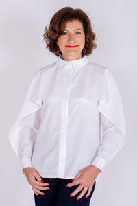 Woman wearing the Barbara Shirt sewing pattern from I AM Patterns on The Fold Line. A shirt pattern made in poplin, viscose, cotton voile, chambray, crêpe, denim or silk fabrics, featuring a classic shirt collar and sleeves, cuffs with a slit opening, bac