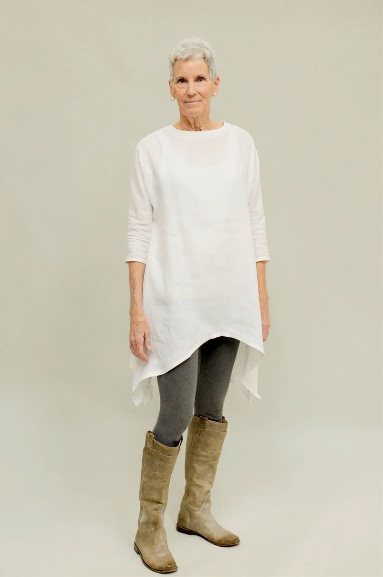 Woman wearing the Basics Tunic sewing pattern from Folkwear on The Fold Line. A tunic pattern made in linen, rayon, silk, cotton batiste, voile or velvet fabrics, featuring a handkerchief hem, side vents, dolman three-quarter length sleeves, roomy fit, ro