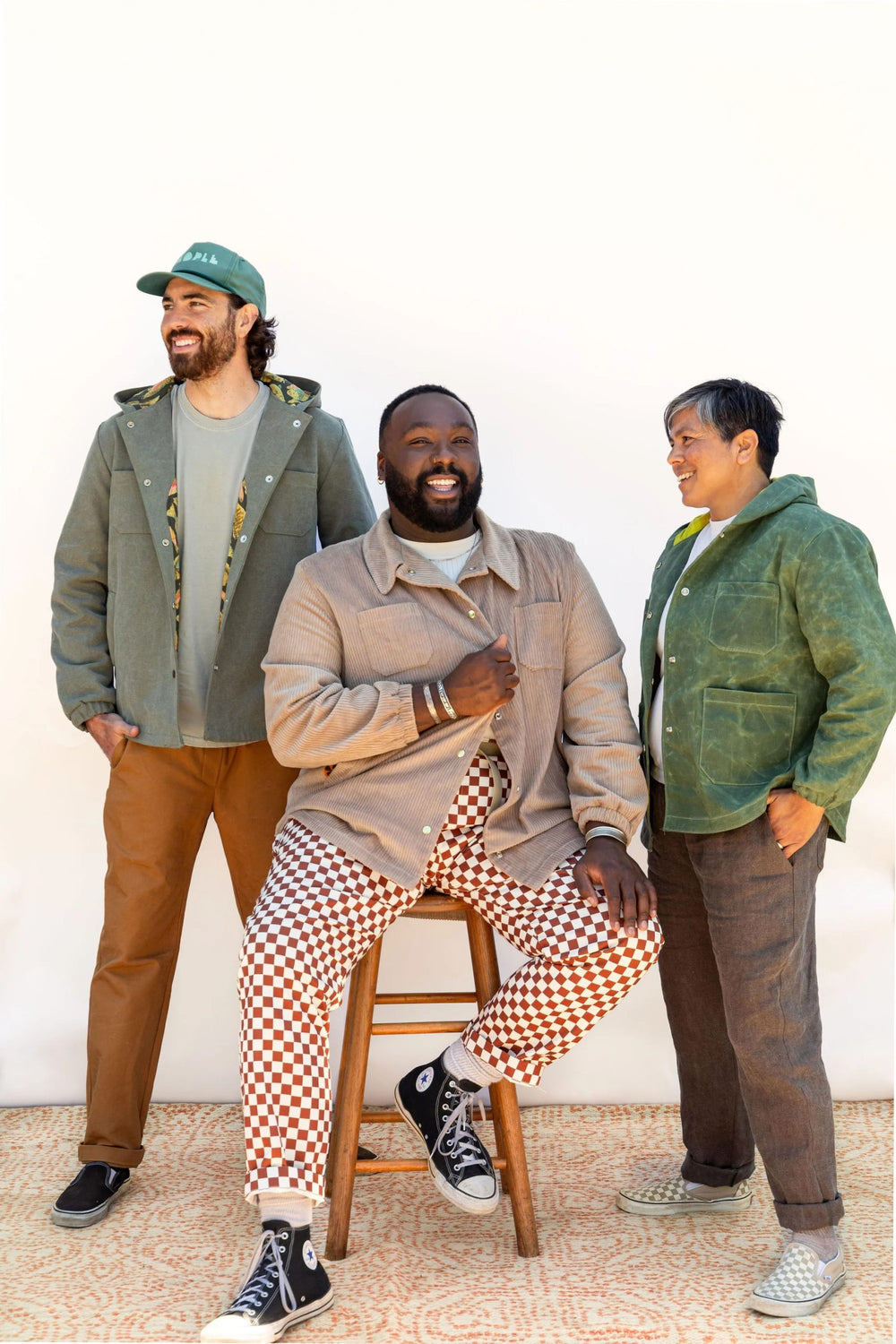 Men wearing the Men’s Beachcomber Jacket sewing pattern from Friday Pattern Company on The Fold Line. A jacket pattern made in denim, twill, or canvas fabric, featuring a lining, patch and welt pockets, a hood or collar, snap front, long sleeves with elas