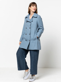 Woman wearing the Beatrice Pea Coat sewing pattern from Style Arc on The Fold Line. A coat pattern made in wool melton, wool twill or gabardine fabrics, featuring a two-piece collar, double-breasted, two-piece sleeves, faux buttoned cuff, in-seam pockets 