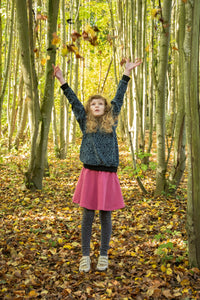 Child wearing the Baby/Child/Teen Becky Skirt sewing pattern by Bobbins and Buttons. A skirt pattern made in stable knits such as ponte roma, French terry and cotton/elastane jersey, featuring a pull-on jersey skater style skirt with an elasticated waist.