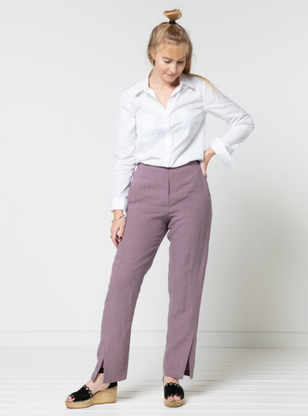 Woman wearing the Bennet Woven Pant sewing pattern from Style Arc on The Fold Line. A trouser pattern made in linen, crepe or light wool fabrics, featuring a straight leg, pull-on style, side leg splits, shaped front waistband, elastic back waistband, fau