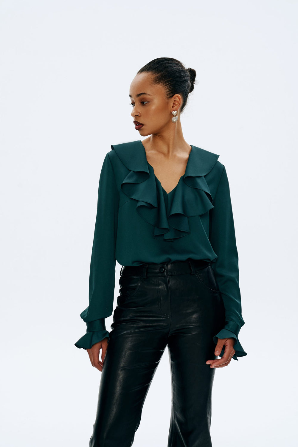Woman wearing the Bertha Blouse sewing pattern from Vikisews on The Fold Line. A blouse pattern made in natural silk, artificial silk, chiffon, crepe de chine, organza or silk crepe fabrics, featuring a semi-fit, straight silhouette, bust darts, back shou