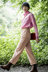 Woman wearing the Betty Trousers sewing pattern from Fibre Mood on The Fold Line. A balloon trouser pattern made in cotton twill, woven jacquard, denim, corduroy or velvet fabrics, featuring a high waist, ankle length, back patch pockets, front pockets, b