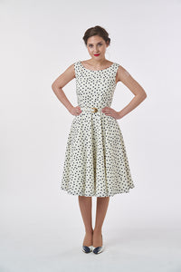 Woman wearing the Betty Dress sewing pattern from Sew over It on The Fold Line. A 1950’s inspired dress pattern made in cotton, cotton lawn, cotton poplin, stretch cotton, cotton sateen, linen, chambray and stable crepes fabrics, featuring a fitted bodice