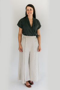 Woman wearing the 231 Big Sky Riding Skirt sewing pattern from Folkwear on The Fold Line. A culottes/skirt pattern made in poplin, denim, gabardine, corduroy, linen, wools or suiting weight silks fabrics, featuring a movable front panel that buttons eithe