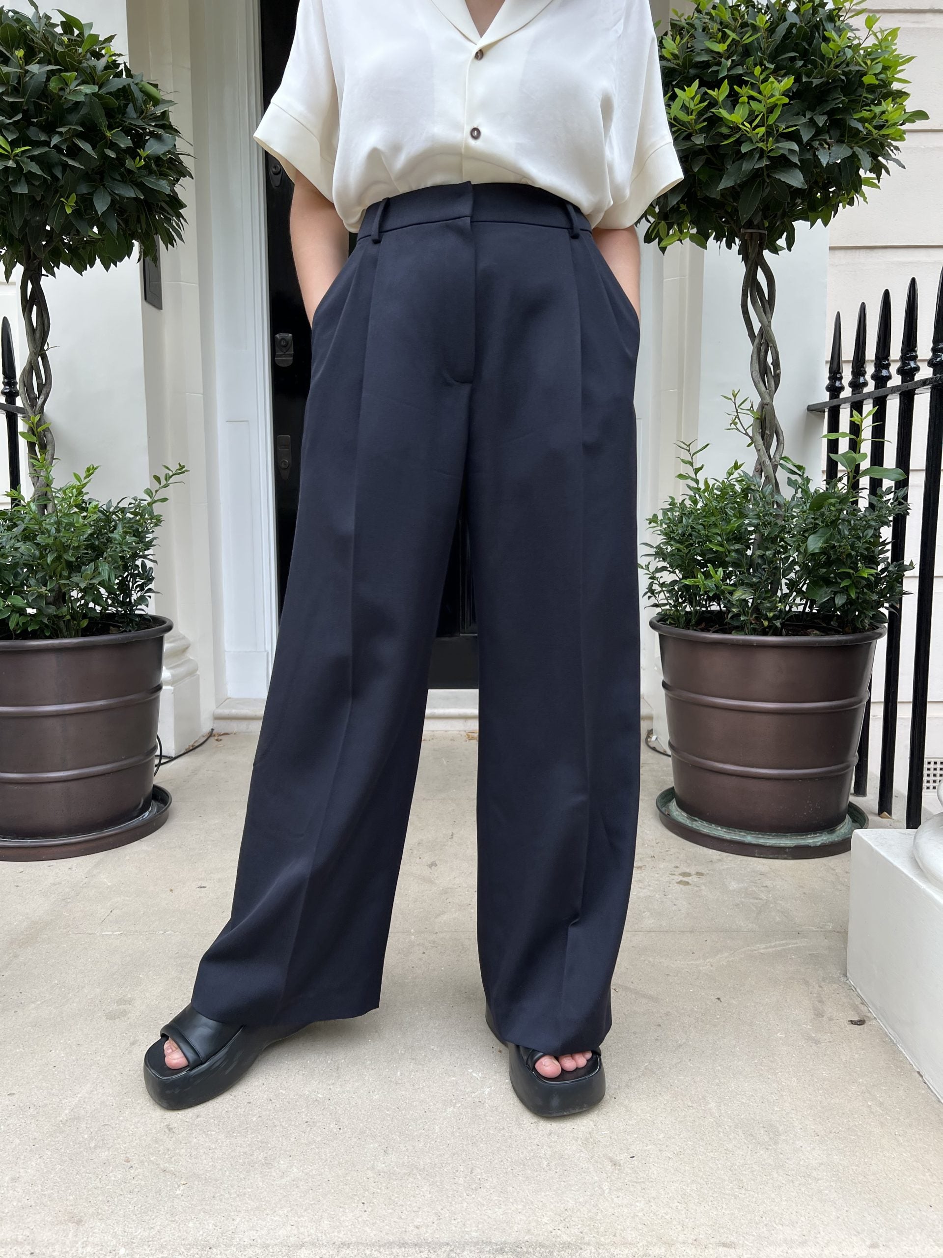 Women wearing the Billy Trousers sewing pattern from Bella Loves Patterns on The Fold Line. A trouser pattern made in wool suitings, wool crepes, wool mohair, wool viscose blends, gabardine or flannel fabrics, featuring a wide-leg, full length, pressed fr