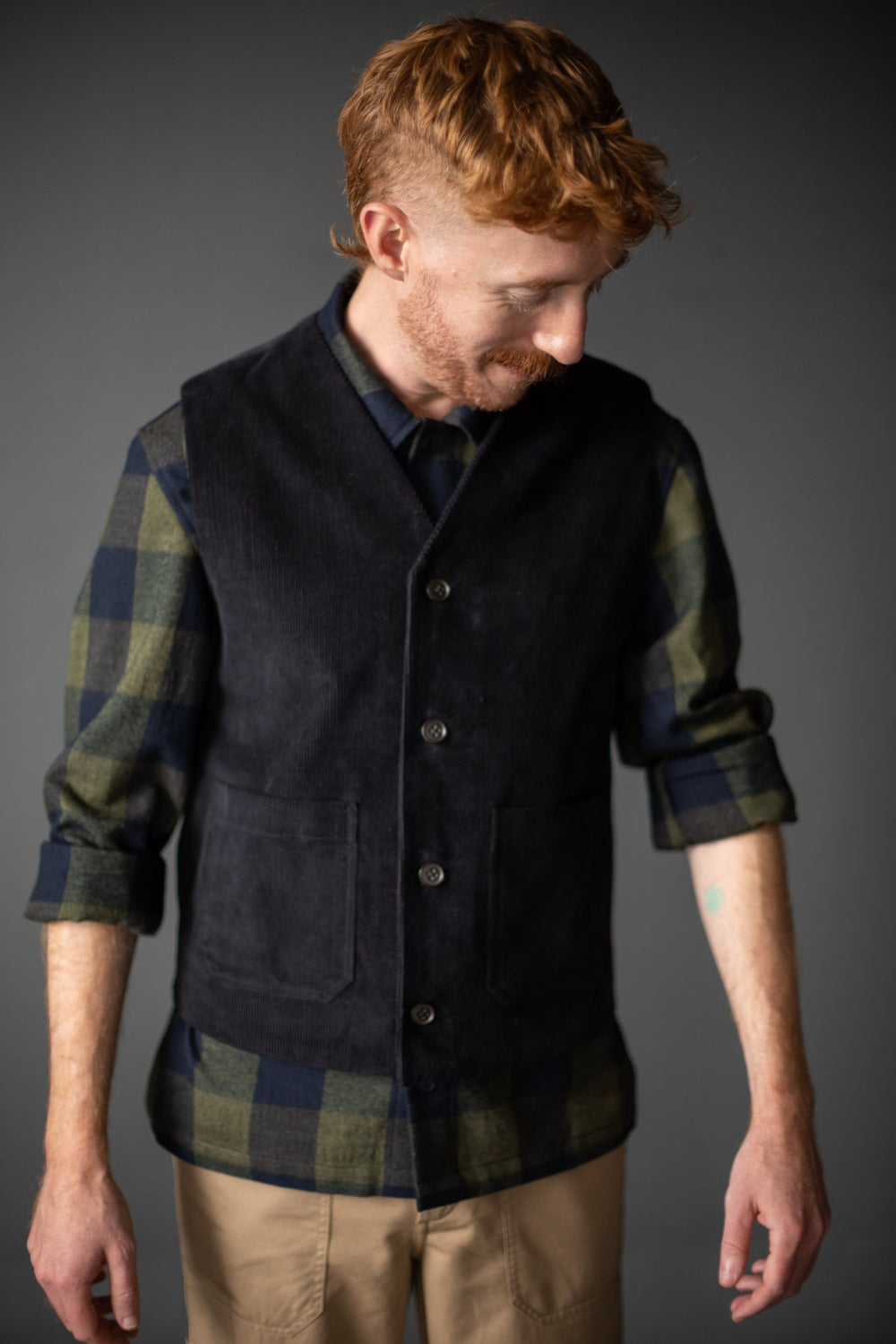 Man wearing The Men's Billy Gilet sewing pattern from Merchant & Mills on The Fold Line. A Gilet pattern made in dry oilskin, oilskin, linen, denim, wool, corduroy, cotton twills or canvas fabrics, featuring front patch pockets, front button closure and V