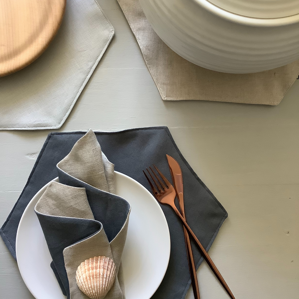 Photo showing the Borage Table Accessories sewing pattern from Lasenby on The Fold Line. A Table Mat, Cup Mat and Napkin pattern made in canvas, linen, Tana lawn, quilting cotton, twill, duck, denim, and thin tweed fabrics, featuring a hexagonal design in