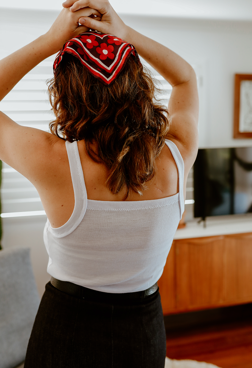 Woman wearing the Bottlebrush Tank sewing pattern from Common Stitch on The Fold Line. A tank pattern made in jersey fabrics, featuring shoulder straps and square neckline.