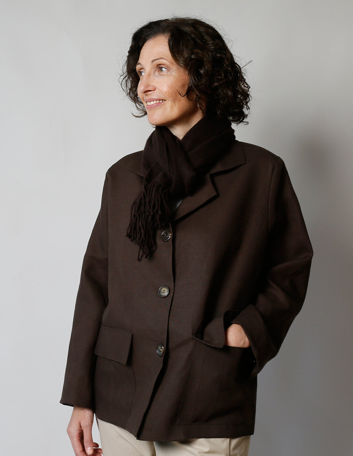 Woman wearing the Boxy Jacket sewing pattern from The Maker's Atelier on The Fold Line. A jacket pattern made in cottons, linens, denim, needlecord, lightweight leather or suede fabrics, featuring front patch pockets, back vent, lined or unlined, back yok