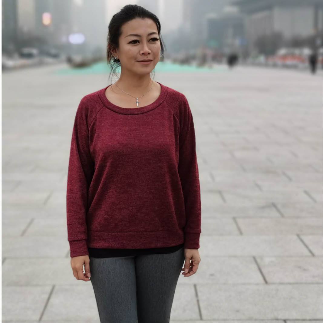 Woman wearing the Boxy Raglan Sweatshirt sewing pattern from Wardrobe by Me on The Fold Line. A sweatshirt pattern made in French terry or sweatshirting fabrics, featuring raglan sleeves, rib crew neckline, full length sleeves, cuffs and hem band, and a b