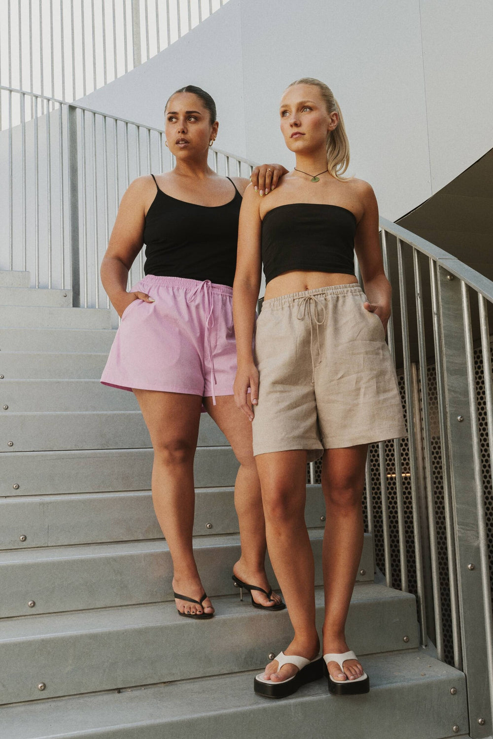 Women wearing the Breezy Shorts sewing pattern from Puff and Pencil on The Fold Line. A shorts pattern made in cotton twill, linen and taslan fabrics, featuring a relaxed fit, elastic waistband with adjustable ties, two front slash pockets, two back patch