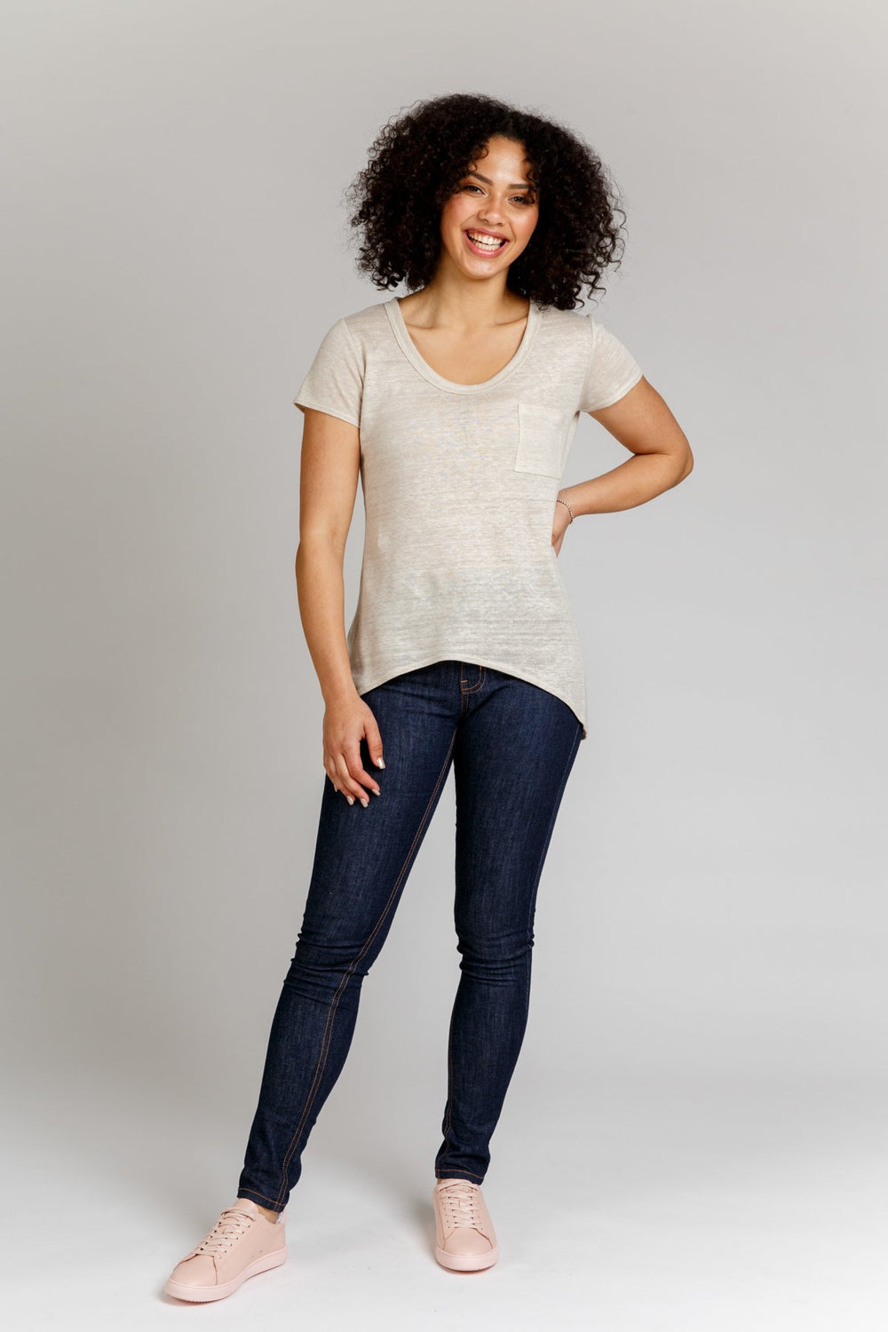 Woman wearing the Briar T-shirt sewing pattern from Megan Nielsen on The Fold Line. A Tee pattern made in jersey fabrics, sweater knits and stable knit fabrics, featuring a high scooped front hem, low curved back hem, short sleeves, chest patch pocket, an