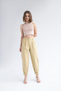 Woman wearing the Britney Pants sewing pattern from Vikisews on The Fold Line. A trouser pattern made in cotton, heavy corduroy, denim or twill fabrics, featuring a loose-fit banana style, front pockets, front waistline tucks fly front zip, back yoke, bac