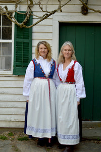 Women wearing the 147 Norwegian Bunad sewing pattern from Folkwear on The Fold Line. A bunad pattern made in linen, cotton, rayon, silk, or wool fabric, featuring a blouse, vest, skirt, and apron.