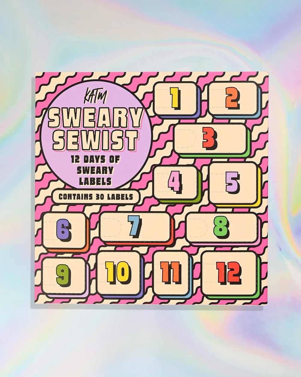 The 2026 Sweary Sewist Advent Calendar from Kylie & The Machine on The Fold Line. The calendar features 30 premium polyester woven labels in 12 windows.