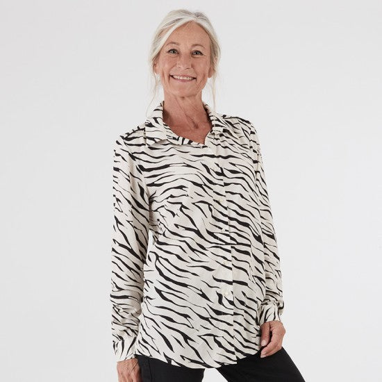 Woman wearing the Adeline Shirt sewing pattern from Coralie Bijasson on The Fold Line. A shirt pattern made in cotton, voile, crepe, or viscose fabric, featuring a collar and collar stand, button front, long sleeves, and shirttail hem.