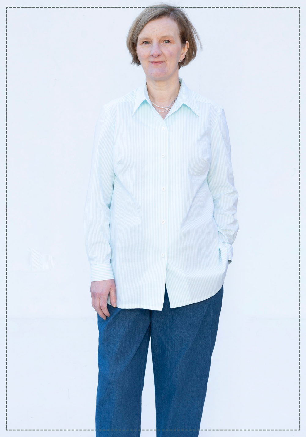 Woman wearing the Amanda Shirt sewing pattern from Bobbins and Buttons on The Fold Line. A shirt pattern made in cotton, needlecord, chambray, lightweight linen, poplin or cotton blend fabric, featuring a collar, button front, back pleat, and long sleeves with cuffs.