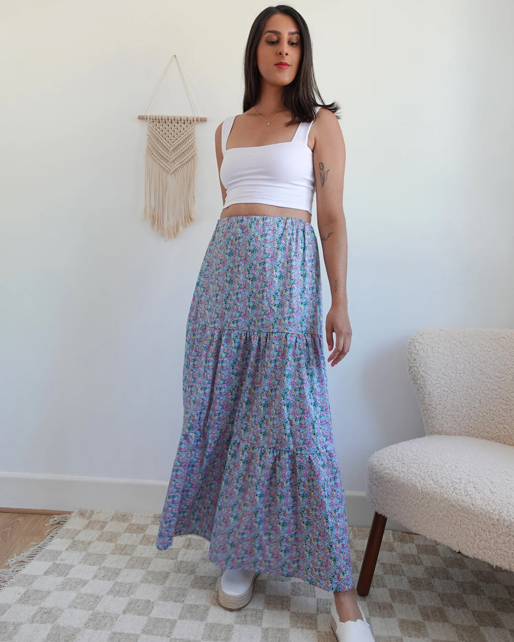 Woman wearing the Amelia Skirt sewing pattern from Tammy Handmade on The Fold Line. A skirt pattern made in cotton, linen, viscose/rayon, or satin fabric, featuring an elastic waist, gathered tiers, and maxi length.