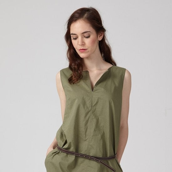 Woman wearing the Anaïs Dress sewing pattern from Coralie Bijasson on The Fold Line. A sleeveless dress pattern made in viscose crepe, silk satin or cotton fabric, featuring a front neckline slit and pockets.