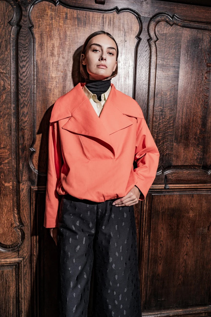 Woman wearing the Anette Jacket sewing pattern from Fibre Mood on The Fold Line. A jacket pattern made in wool, loden, denim, corduroy, teddy, or faux fur fabric, featuring large lapels, side pockets, and an elasticated hem.