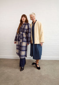 Women wearing the Arbre Coat sewing pattern from Fabric Godmother on The Fold Line. A coat pattern made in boiled wool, felt, puffer, denim, fleece, sherpa, quilted or jacquard fabric, featuring a relaxed fit, raglan sleeves, hip or mid-calf length, and press studs or a tie belt.