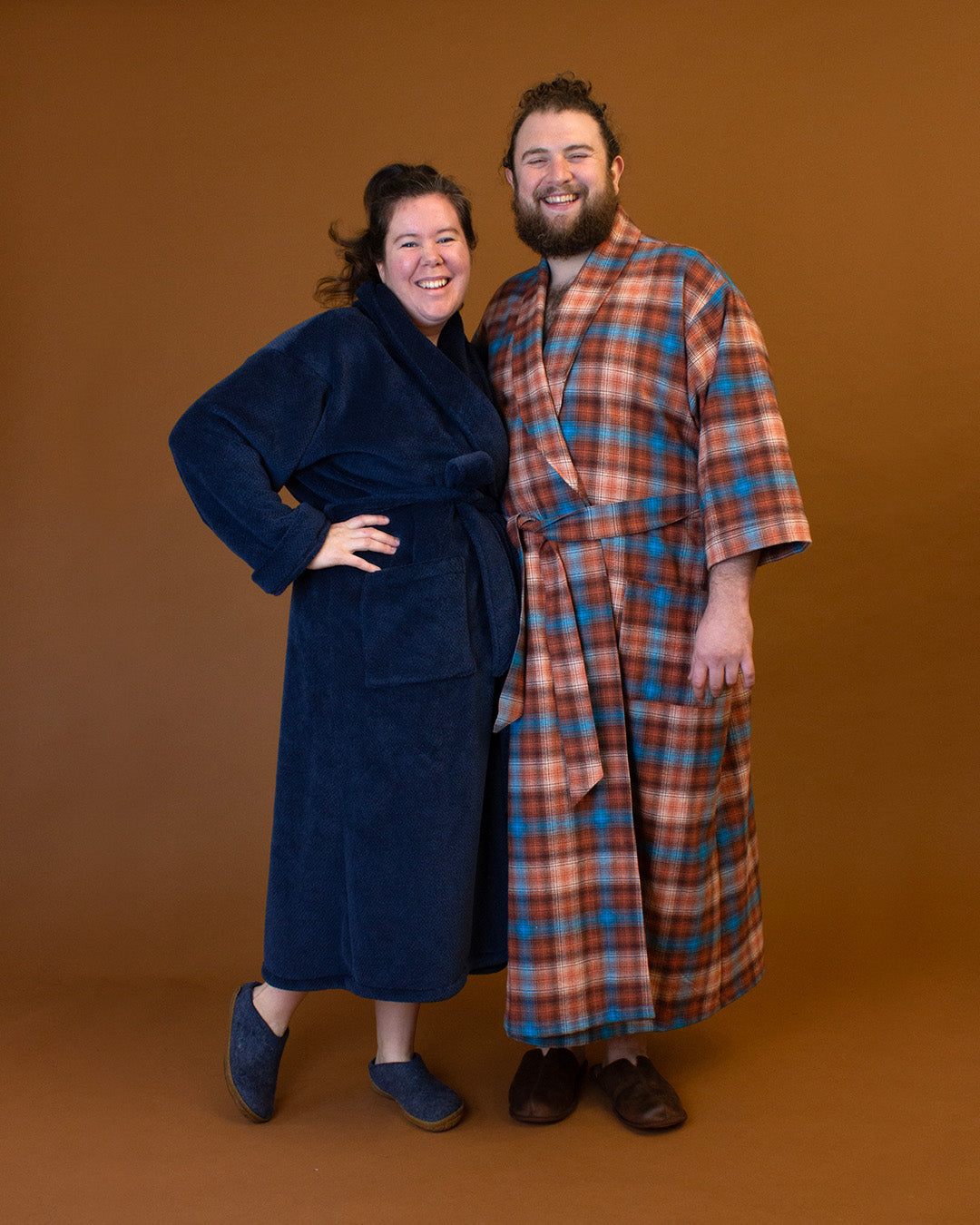Man and woman wearing the Arbutus Robe sewing pattern from Helen's Closet on The Fold Line. A dressing gown pattern made in linen, cotton, silk, wool, hemp, rayon/viscose challis, satin, tencel, terry cloth, waffle, velour, or fleece fabric, featuring a relaxed fit, shawl collar, tie, and pockets.