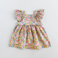 The Baby/Child Amelia Dress sewing pattern from Oh Me Oh My Sewing on The Fold Line. A dress pattern made in quilting cotton, washed linen, double gauze, cotton lawn, voile, or rayon challis fabric, featuring an oversized fit, square yoke, flutter sleeves, low back, high waist, and gathered skirt.